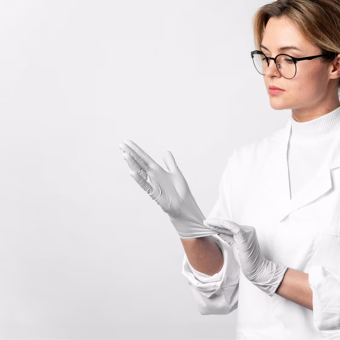 A doctor putting on surgical gloves