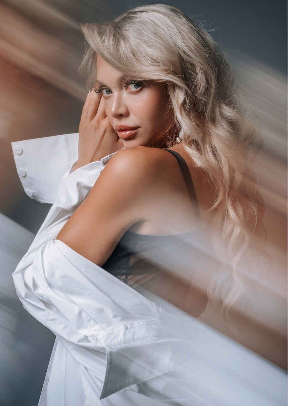A blonde model in a white shirt, caught in motion blur